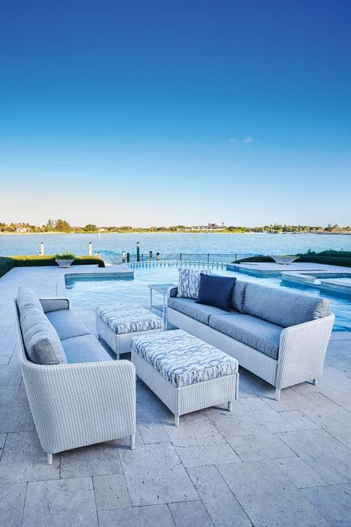 Lloyd Flanders Visions sofas and ottomans in Matte White by a pool