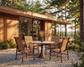 Woodard Louie 5-Piece Dining Set, shown in a Woodard outdoor setting (shown in sling with the Light Travertine top; the vase is not included)