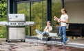 Napoleon Prestige 500 stainless steel gas grill on a modern wood deck patio
