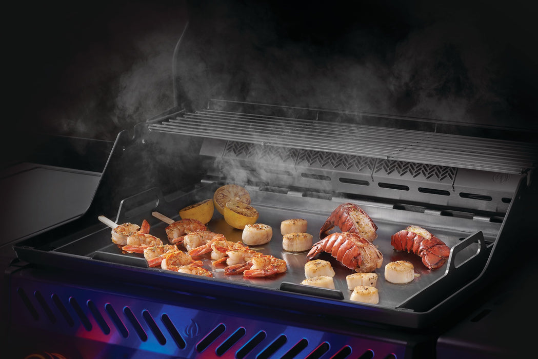 Napoleon stainless steel griddle insert with shrimp, scallops and vegetables cooking
