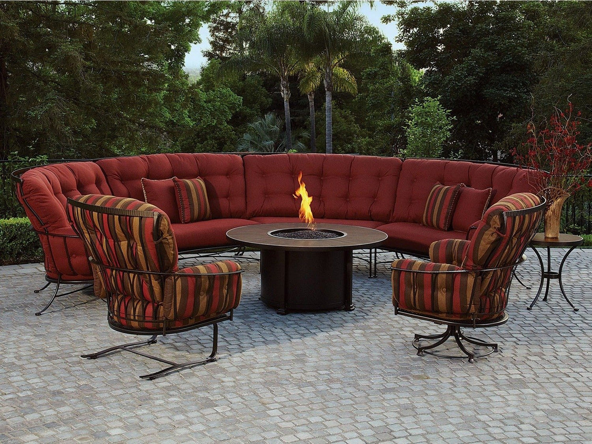 OW Lee Capri round fire table with a red curved sectional