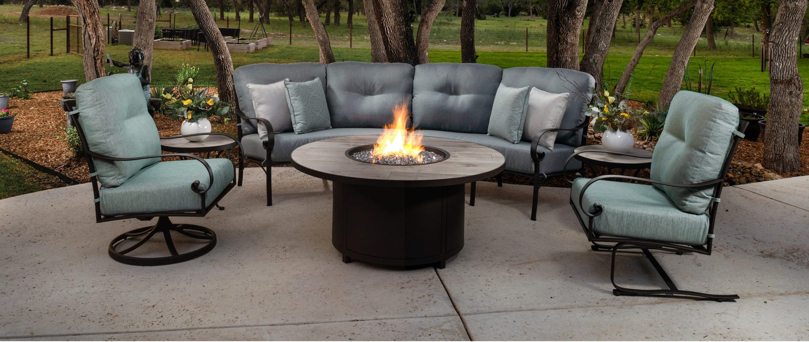 O.W. Lee Pasadera curved sectional, swivel rocker and spring base chair around a fire table