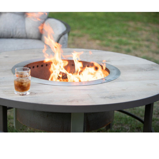 OW Lee Compass wood-burning fire table with a Breeo X24 Corten fire pit burning