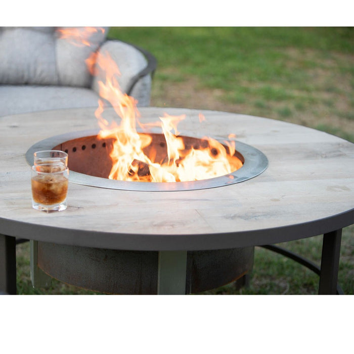 OW Lee Compass wood-burning fire table with a Breeo X24 Corten fire pit burning