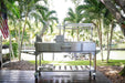 Tagwood BBQ06SS on a waterfront deck under palm trees