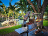 Tagwood BBQ06SS cooking on a waterfront deck with the clamp grill raised