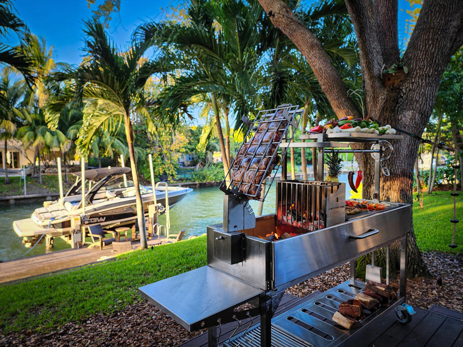 Tagwood BBQ06SS cooking on a waterfront deck with the clamp grill raised