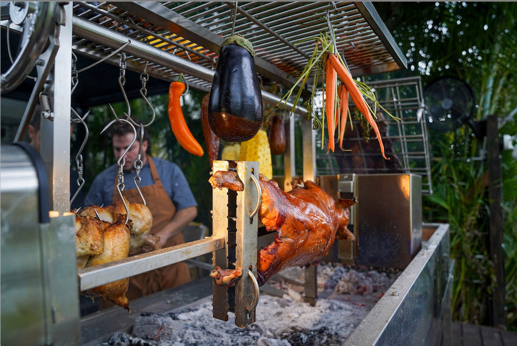 Chickens and vegetables on the Tagwood rotisserie over the fire