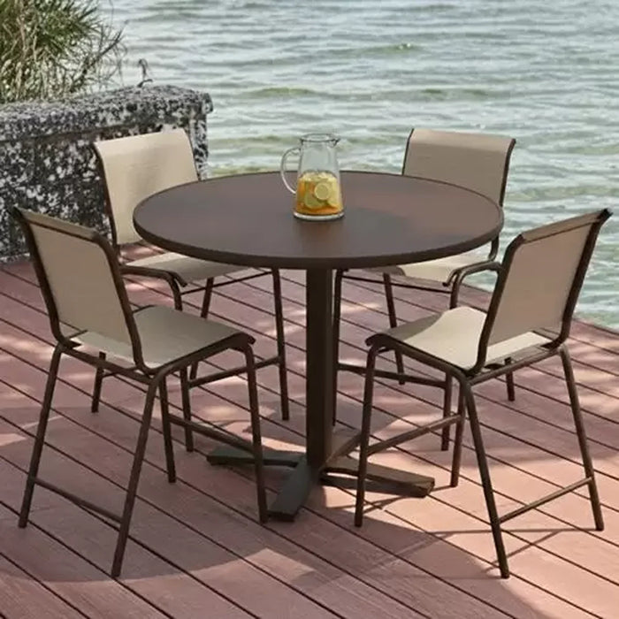 Telescope Casual Cascade bar-height table with sling bar chairs on a waterfront deck