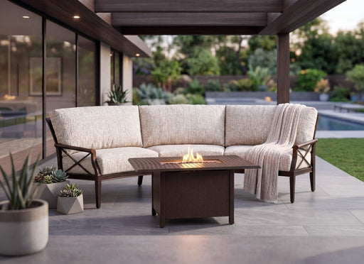 Woodard Andover crescent sofa around a fire table on a covered patio (fire table sold separately)