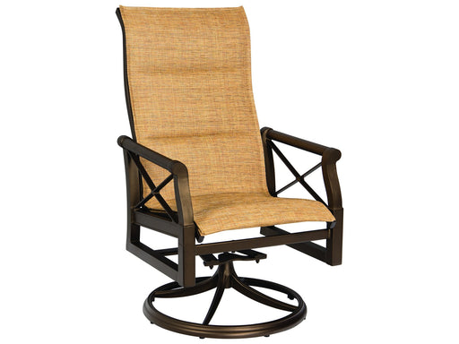 Woodard Andover Padded Sling High-Back Swivel Rocking Dining Arm Chair in an outdoor setting