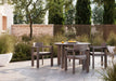 Woodard Beau 5-piece dining set: 48-inch round table with four dining arm chairs on a patio
