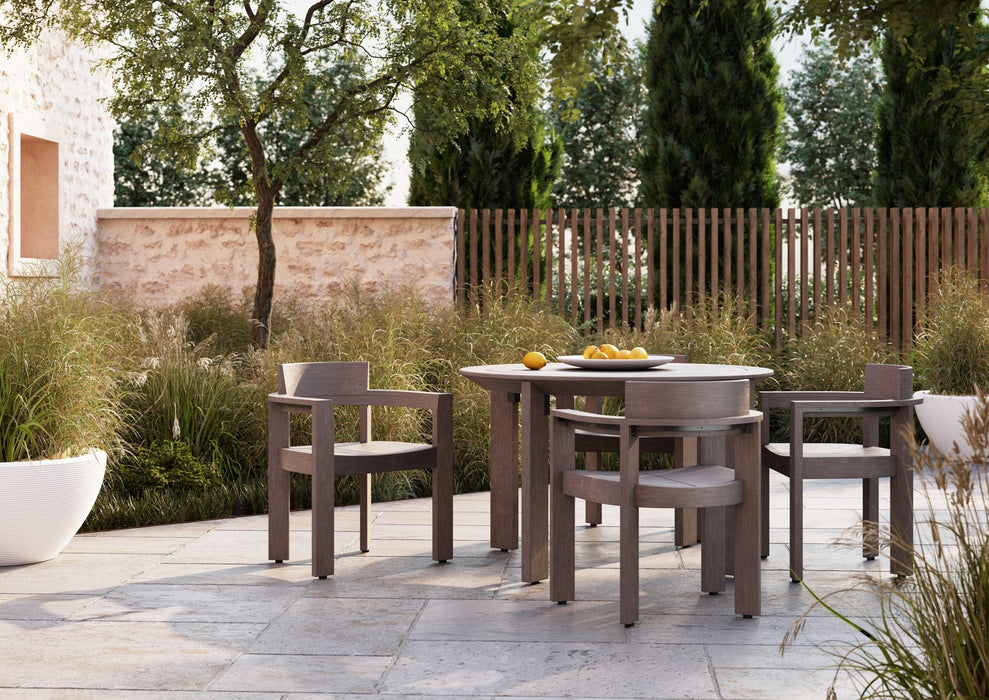 Woodard Beau 5-piece dining set: 48-inch round table with four dining arm chairs on a patio