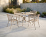 Woodard Briarwood barrel dining chairs around a round table on a modern patio