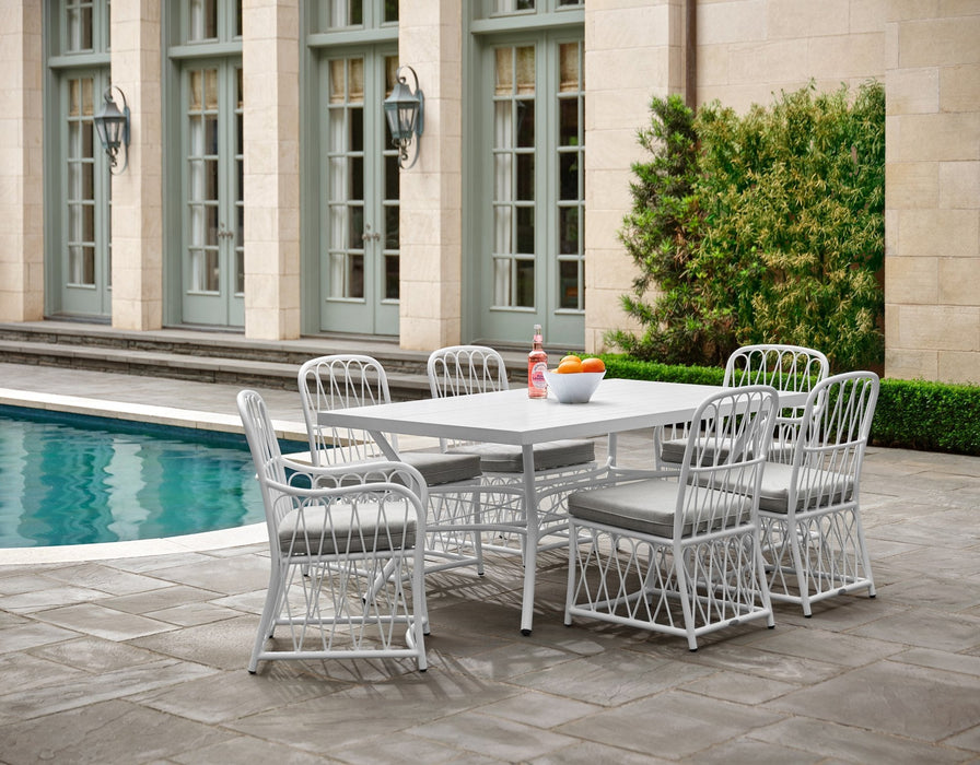 Woodard Cane 7-piece dining set in White: rectangular table, two arm chairs and four side chairs by a pool