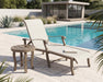 Woodard Cortland sling chaise lounge with a side table