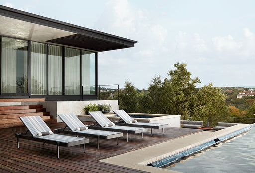 Woodard Daytona sling chaise lounges on a pool deck (four shown; this set includes two)