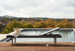 Woodard Daytona sling chaise lounge with its back raised, beside an infinity pool