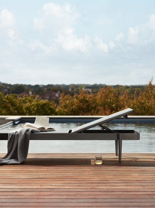 Woodard Daytona sling chaise lounge on a wood pool deck