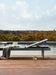 Woodard Daytona sling chaise lounge on a wood pool deck