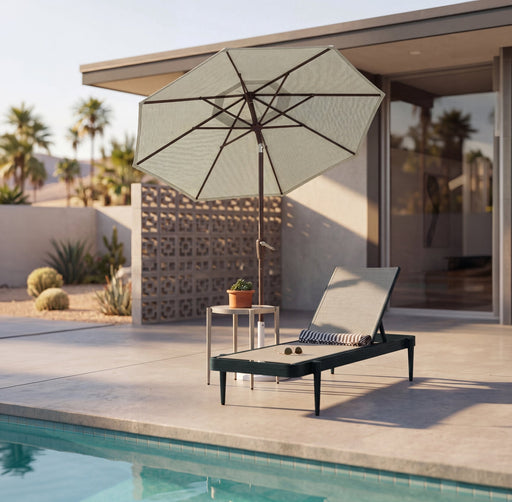 Woodard Daytona sling adjustable chaise lounge by a pool, with a side table and umbrella (sold separately)