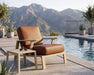 Woodard Elevation lounge chair with side table by a pool