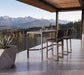 Woodard Harper 3-piece bar set: two Harper bar stools and the Profile sintered stone bar table on a mountain-view terrace