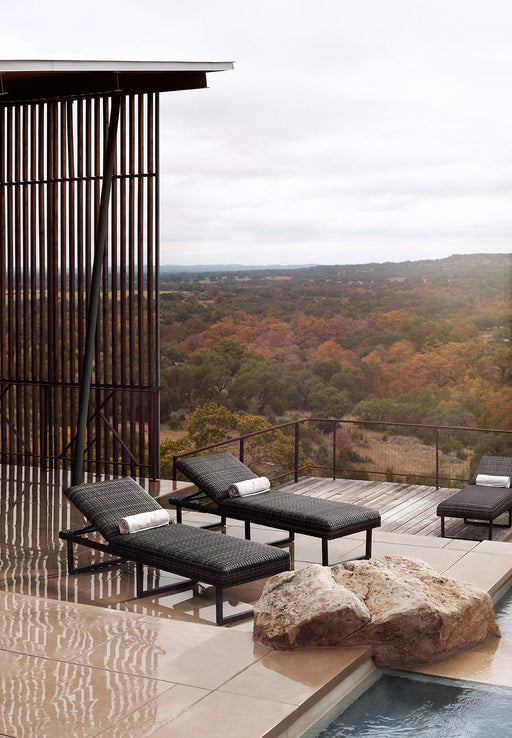 Woodard Harper chaise lounges on a pool deck overlooking the hills