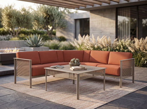 Woodard Jax 3-piece L-shape sectional with rust cushions on a patio (coffee table and decor sold separately)