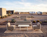 Woodard Juno 4-piece lounge set: sofa, two lounge chairs and Tri-Slat Elite coffee table on a desert patio