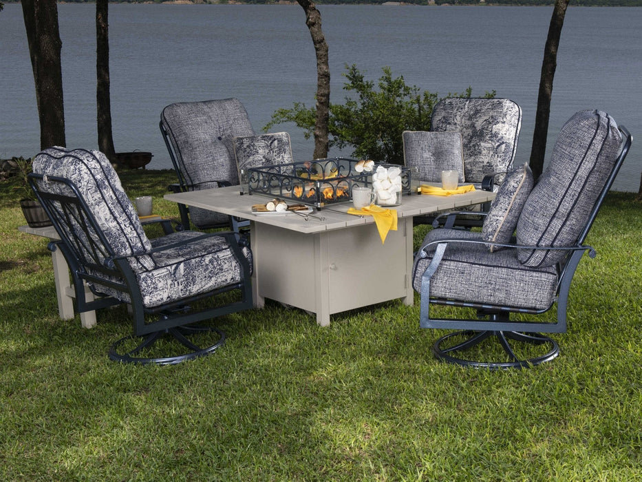 Woodard Cortland Big Man's Swivel Rocking Lounge Chair, around a fire table by the water
