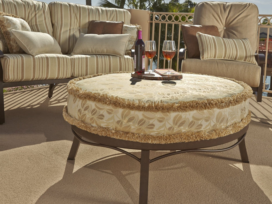 Woodard Cortland Spring Lounge Chair, with the Universal Oval Ottoman on a patio