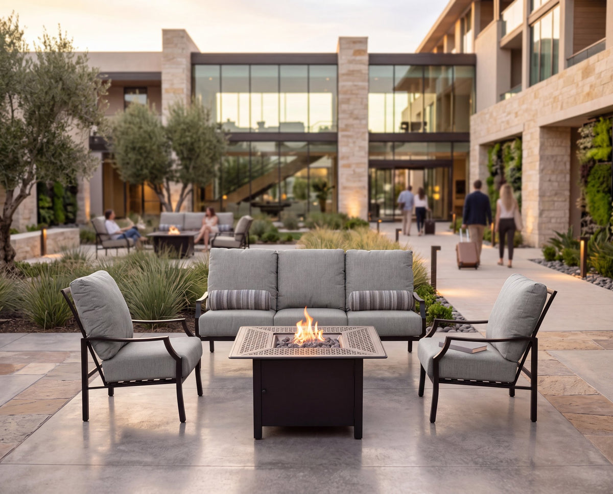 Woodard Nico lounge set around a fire table in a hotel courtyard