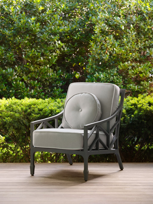 Woodard 16 inch round button pillow on a Woodard lounge chair
