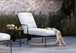 Woodard Reed chaise lounge with white cushions by a pool