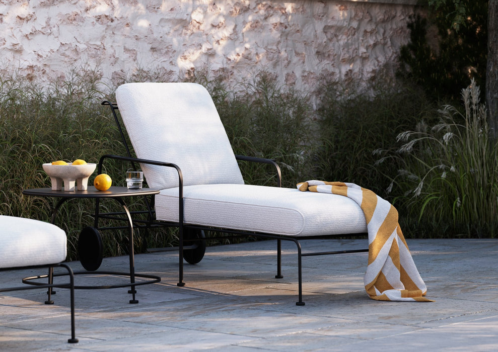 Woodard Reed chaise lounge with white cushions by a pool