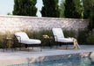 Woodard Reed chaise lounges with two square side tables by a pool (set includes one table; add a second as an option)