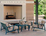Woodard Elevation love seat and two lounge chairs by an outdoor fireplace (the set includes the Elevation side table; coffee table shown not included)