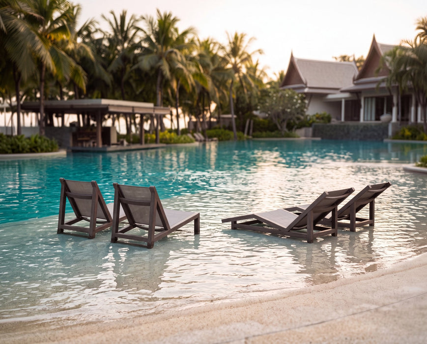 Woodard Sierra Baja sling chairs and chaises at a resort pool (some pieces shown are sold separately)