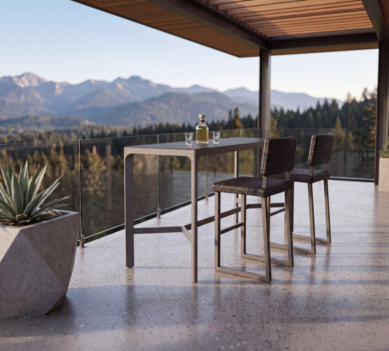 Woodard Harper bar stools at the Profile sintered stone bar table on a mountain-view terrace