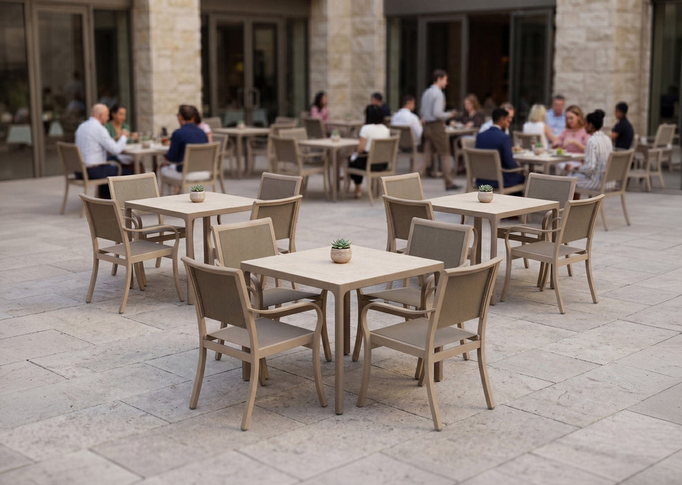 Woodard Profile 36" square sintered stone dining tables with sling dining chairs on a restaurant patio
