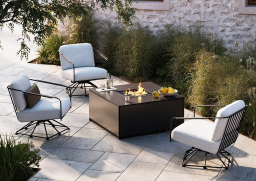 Woodard Reed swivel lounge chairs around the Essence solid panel fire table