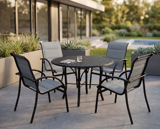 Woodard Thatch top round Tribeca base dining table with four sling dining chairs on a modern patio