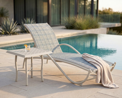 Woodard Thatch top square side table beside a sling chaise by a pool