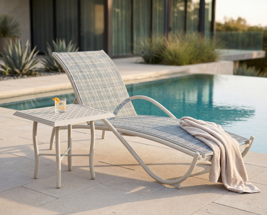 Woodard Thatch top square side table beside a sling chaise by a pool