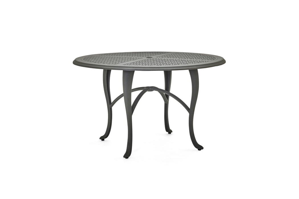 Woodard Hampton Top Cabriole Base round dining table in a lighter finish