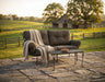 Woodard Terrace crescent love seat with a wrought iron coffee table