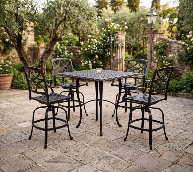 Woodard Wiltshire swivel bar stools around a Hampton bar table in a stone courtyard
