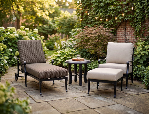 Woodard Wiltshire adjustable chaise lounge and a lounge chair with ottoman in a courtyard garden